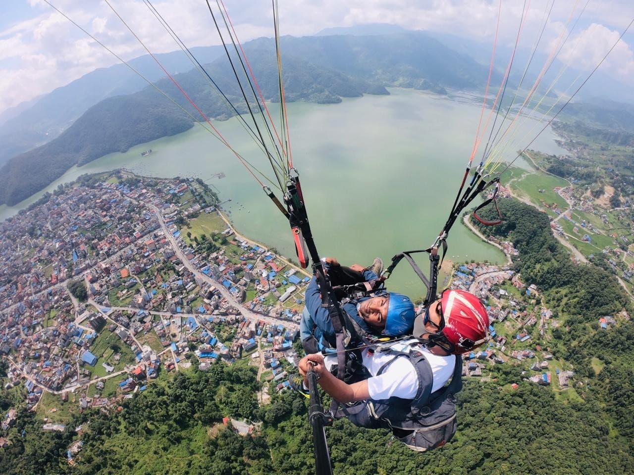 Paragliding above a lake and hills