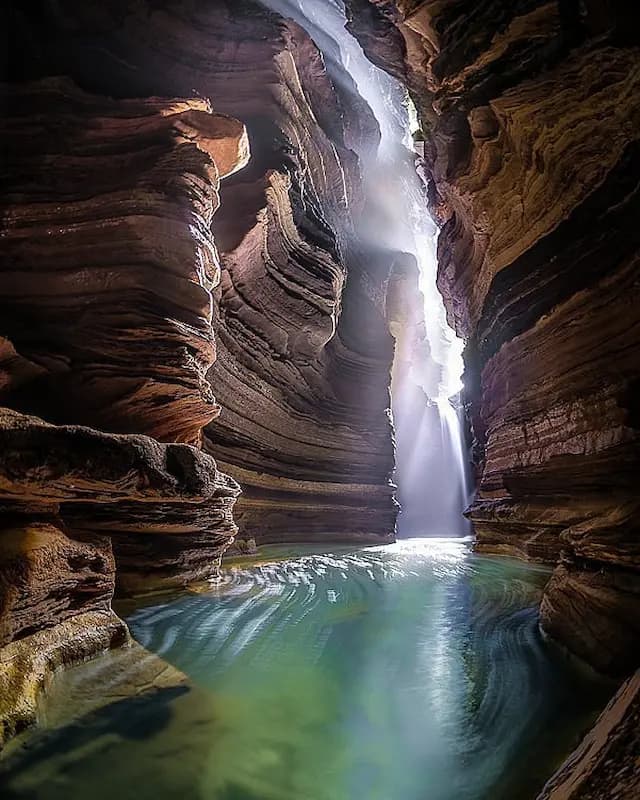 Glowing cave interior with stalactites and rock formations